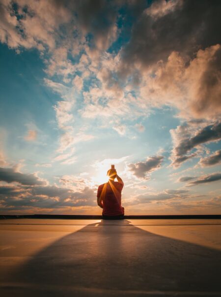 photo of person sitting during golden hour