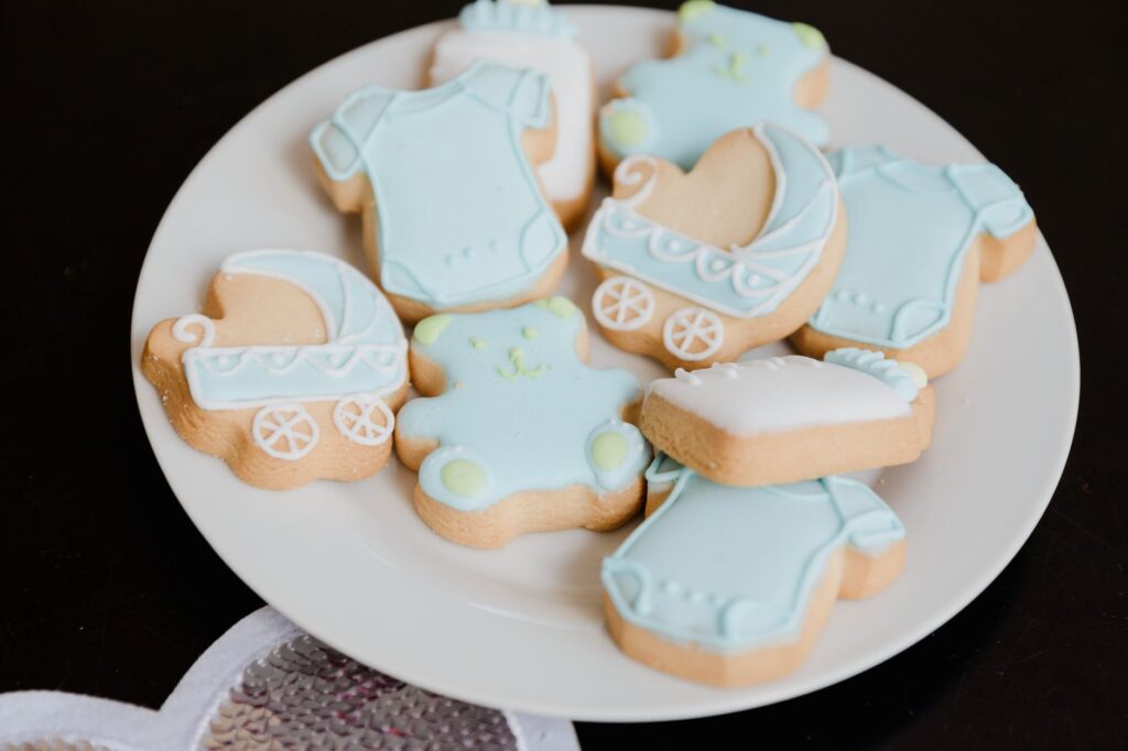cookies in the shape of baby clothes and strollers