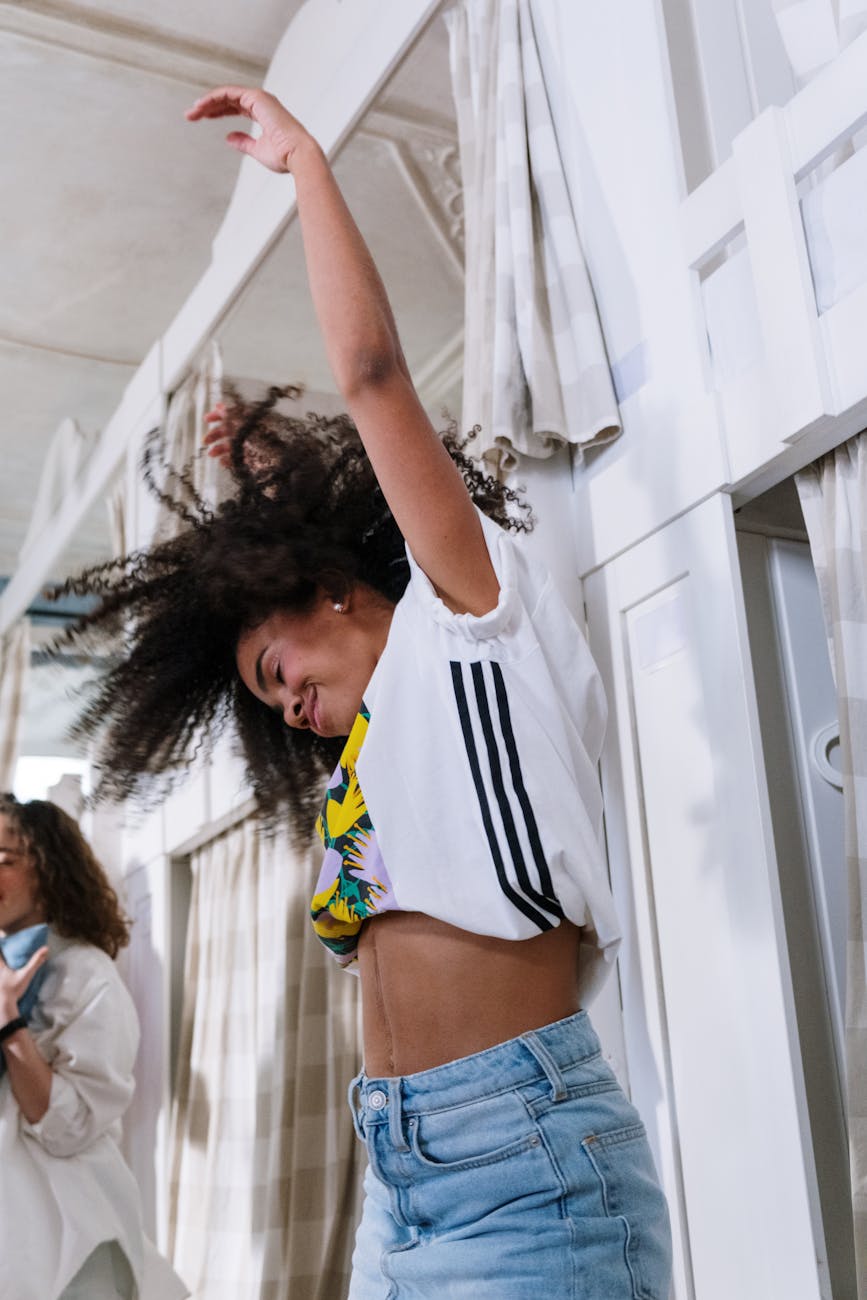 woman dancing beside a bunk bed