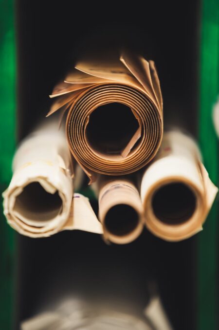 stack of rolled paper between green walls