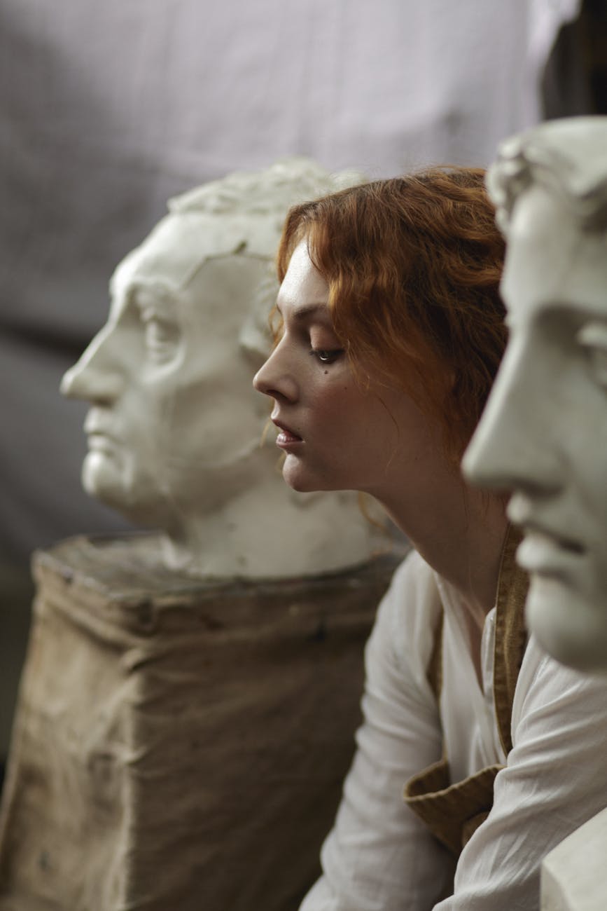 photo of a woman sitting beside statue