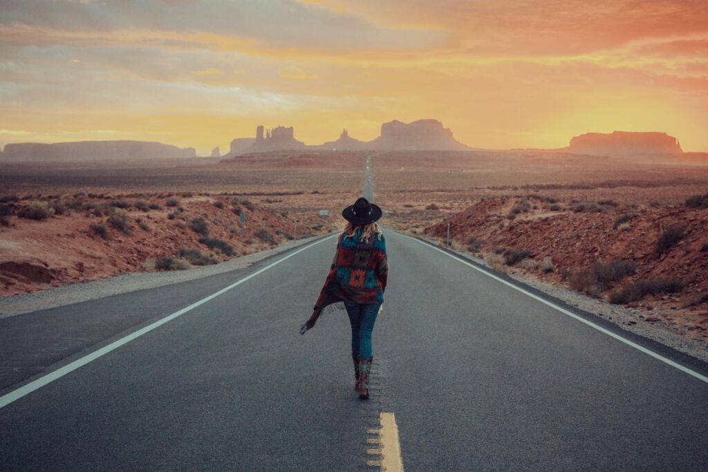 a woman walking on a paved road