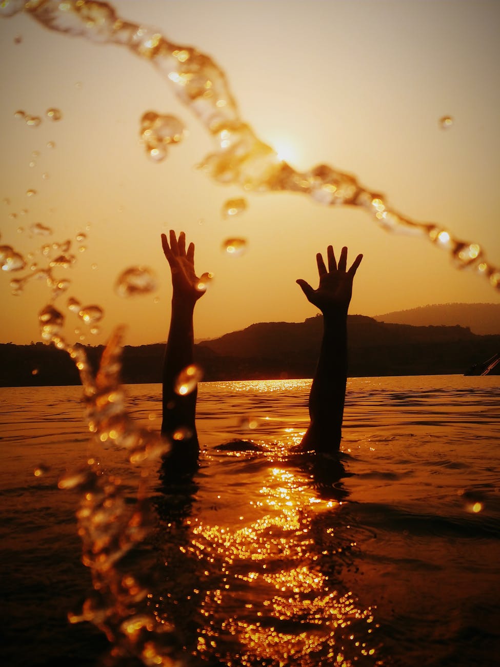 hands above water