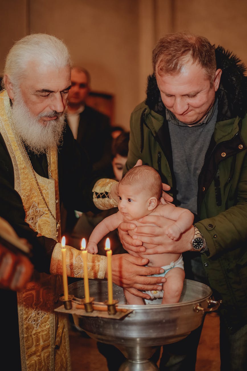 christening of a baby held by their father