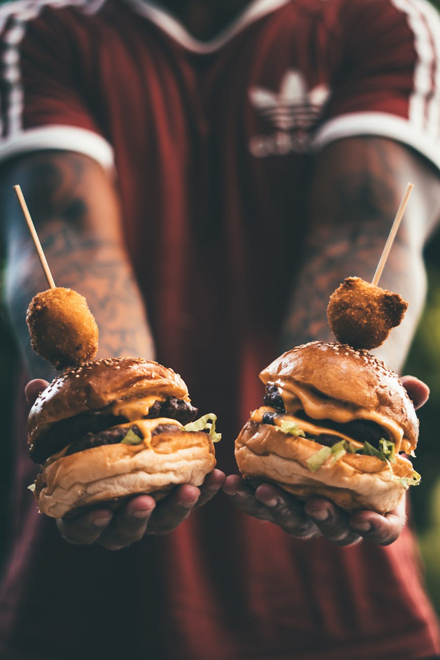 person holding two hamburgers