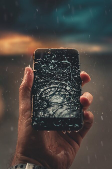 photo of person holding wet smartphone