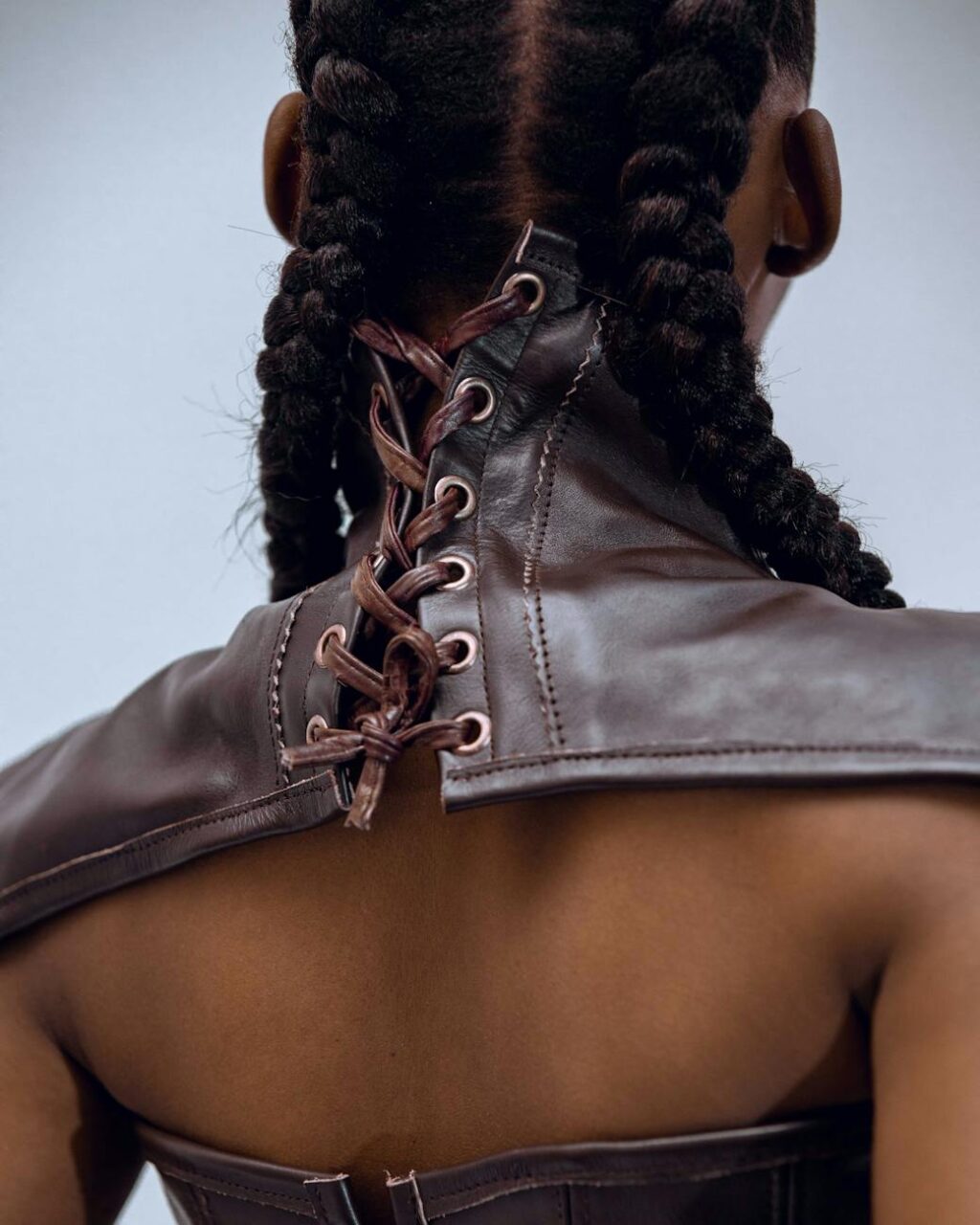 fashionable back view of braided hair and leather corset