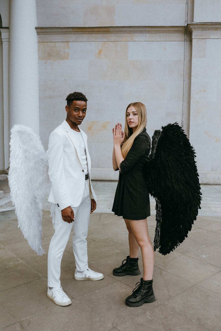 a man and woman wearing angel costumes