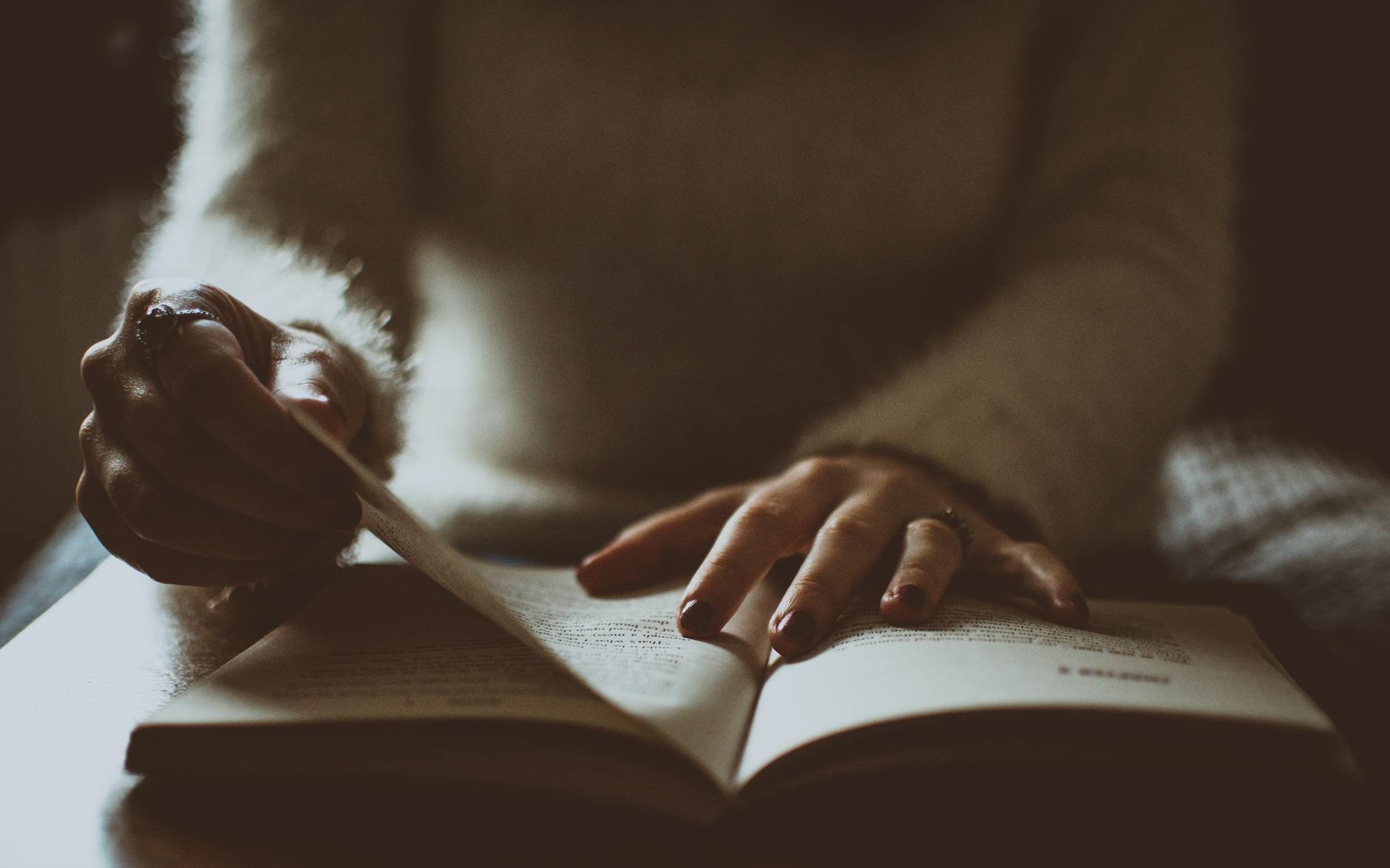 photo of person flipping book page