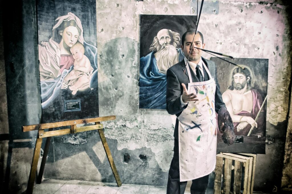 painter with apron beside portrait paintings