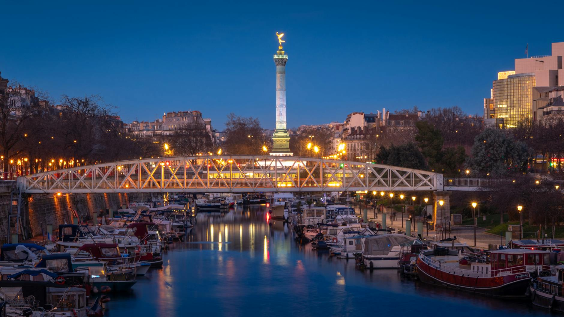 bridge and moored motorboats in paris in evening