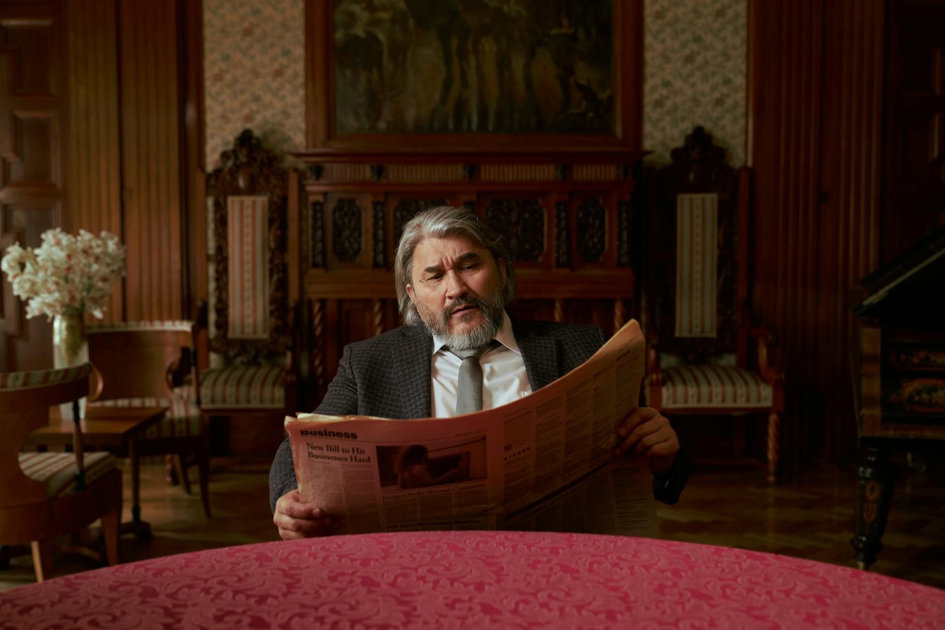 old man reading newspaper