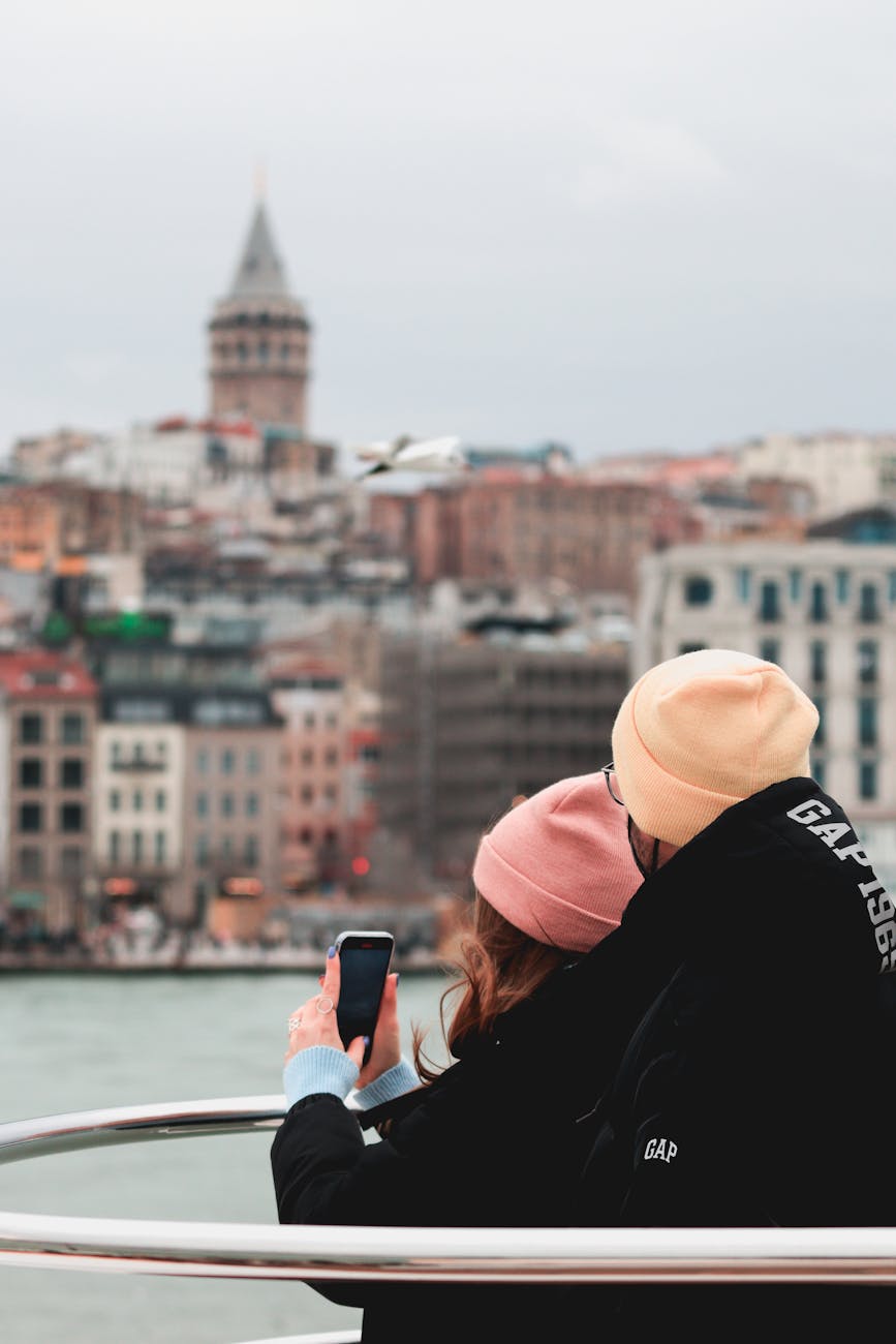 couple wearing black jackets and beanie hats