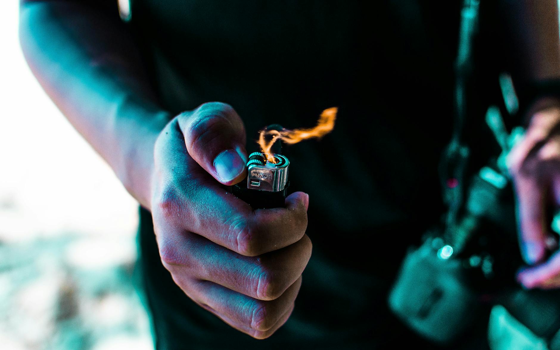 person holding lighted lighter
