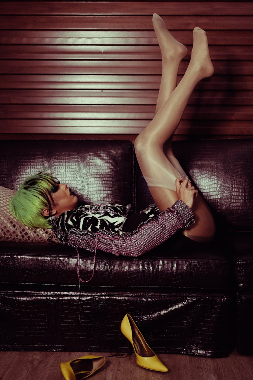 transgender woman lying on sofa with legs raised alluringly