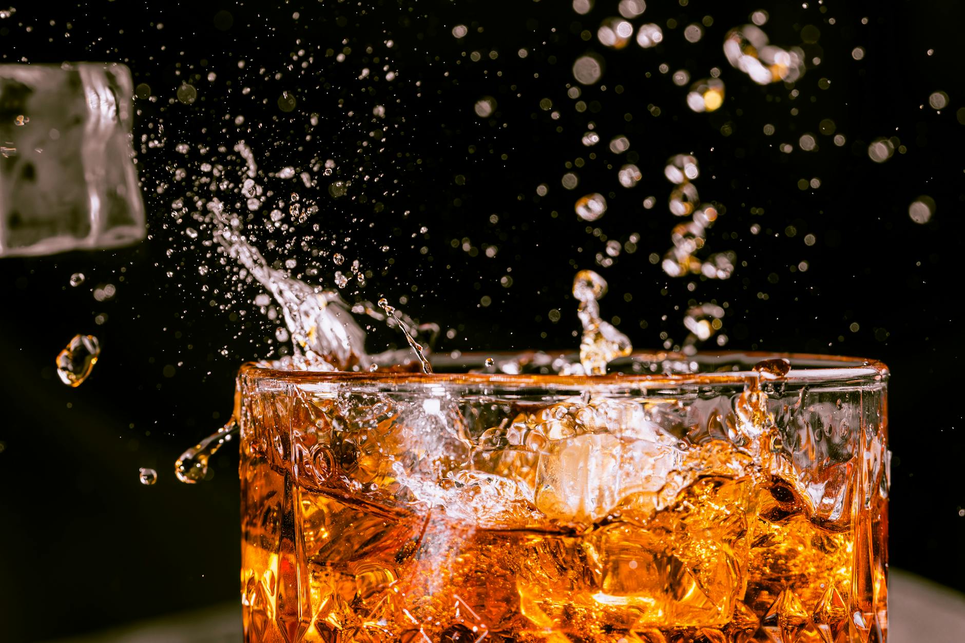 a glass of whiskey being poured into a glass