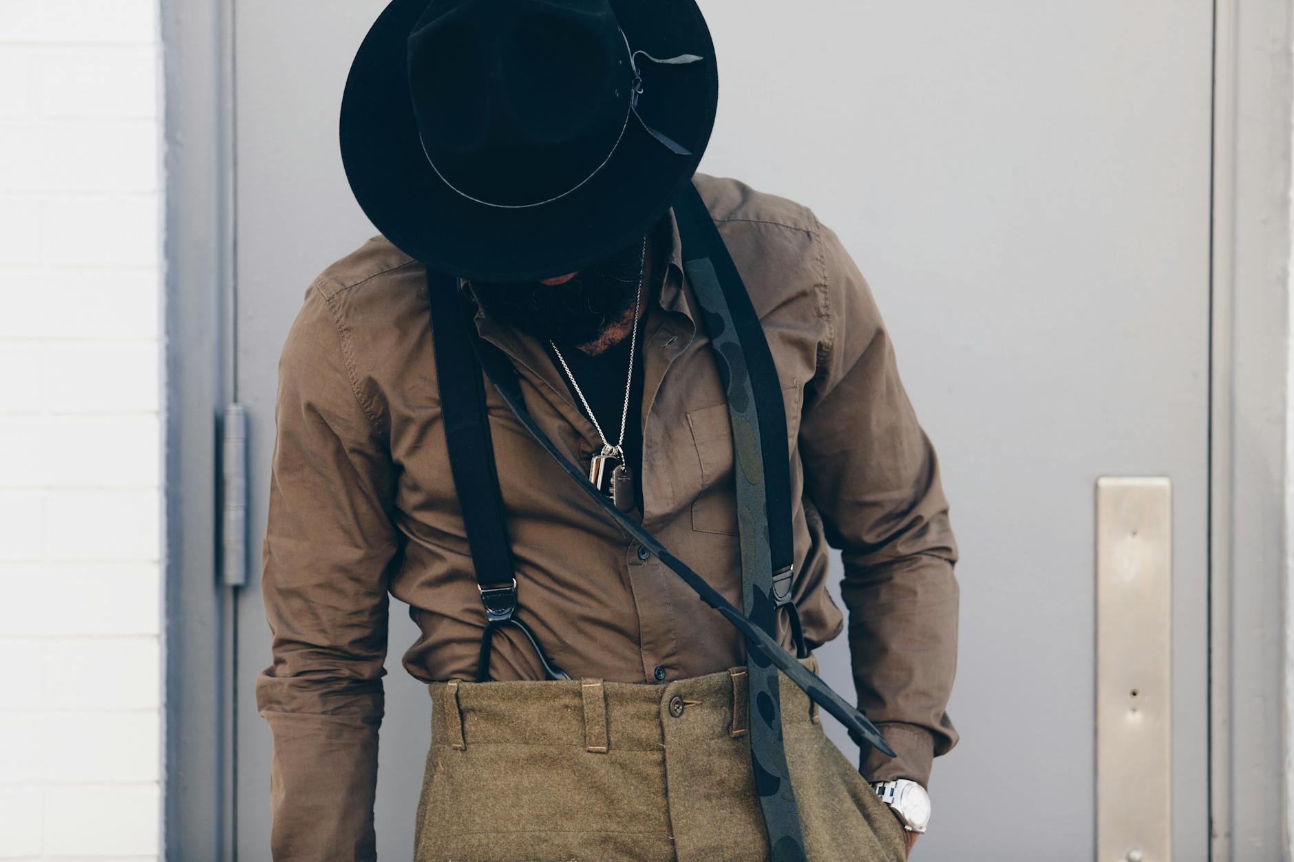 photo of person wearing brown dress shirt