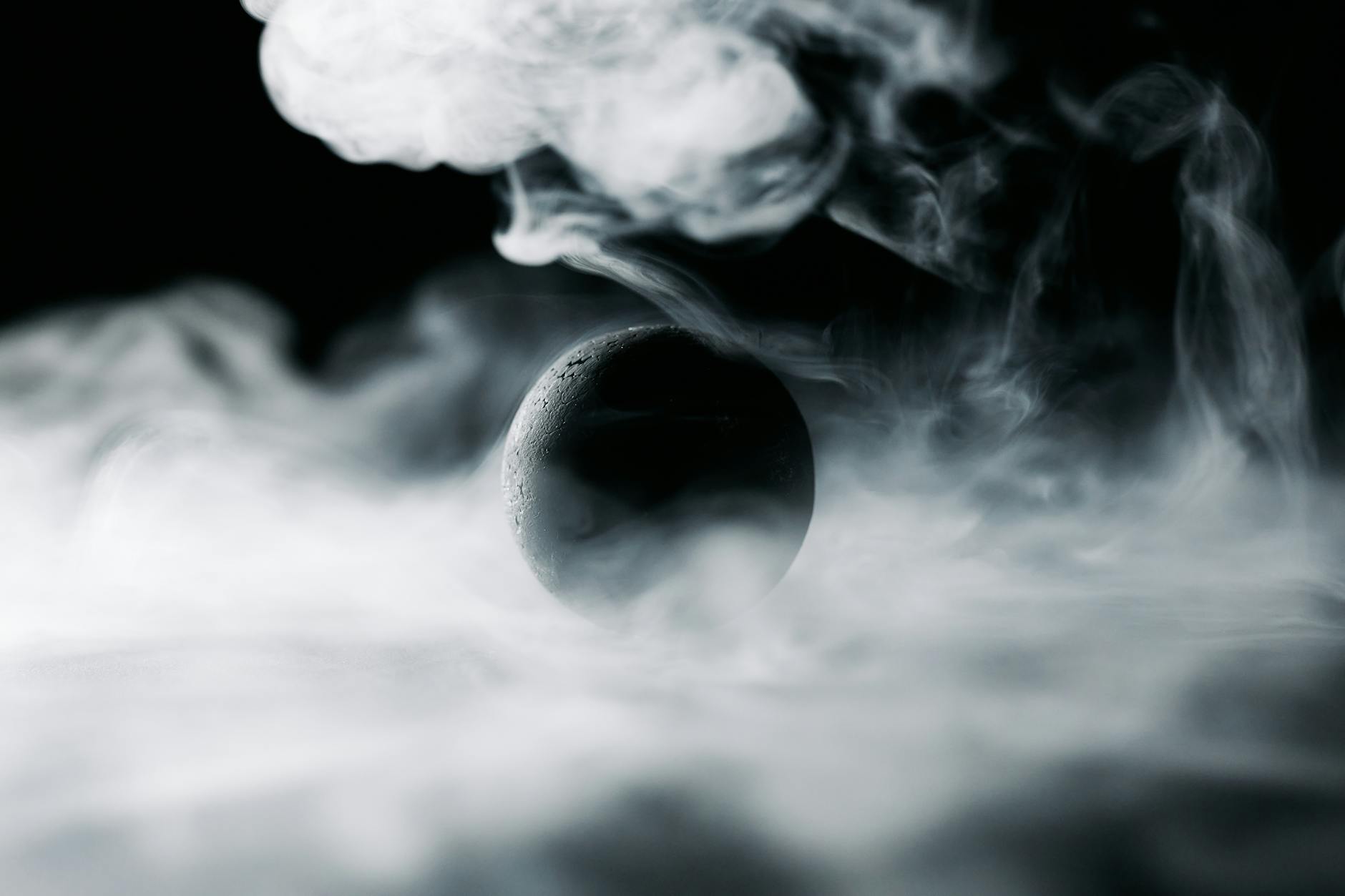 a black ball surrounded by smoke