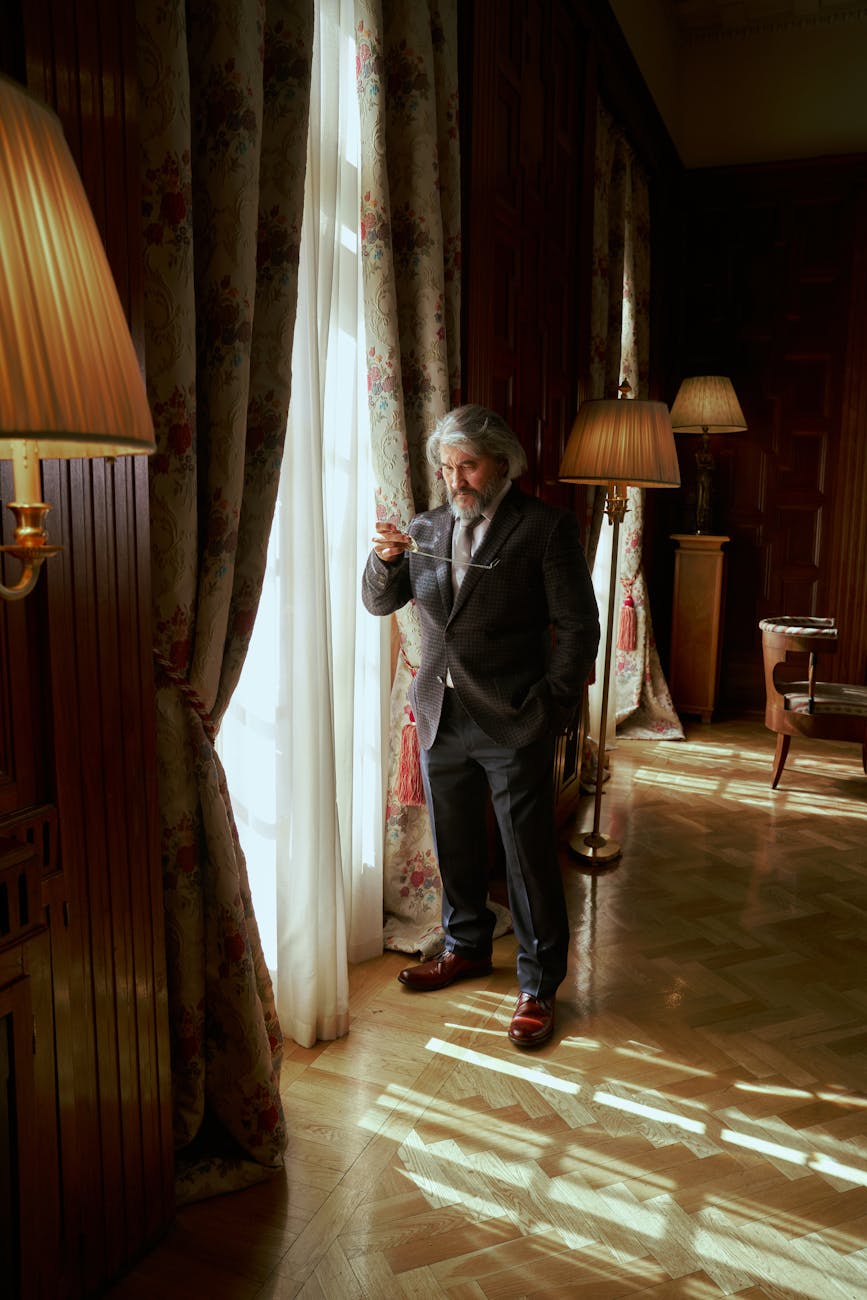 elderly nobleman standing by the window
