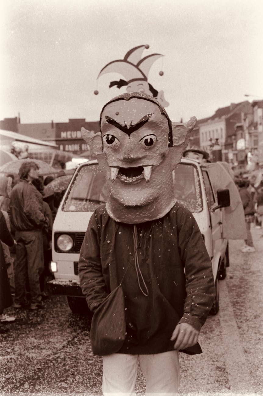 a man wearing a mask on the street in sepia