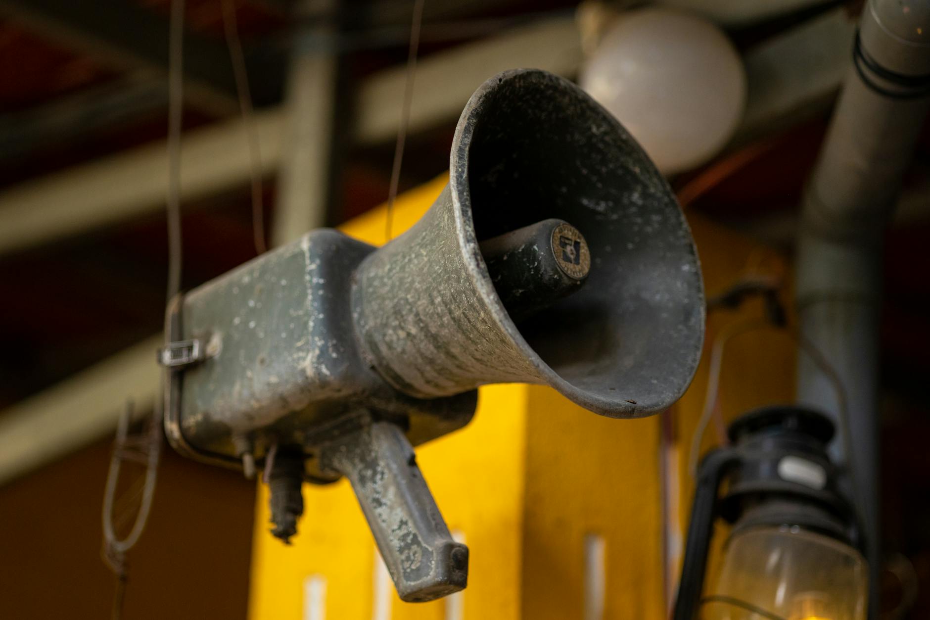vintage loudspeaker hanging in a market in vietnam