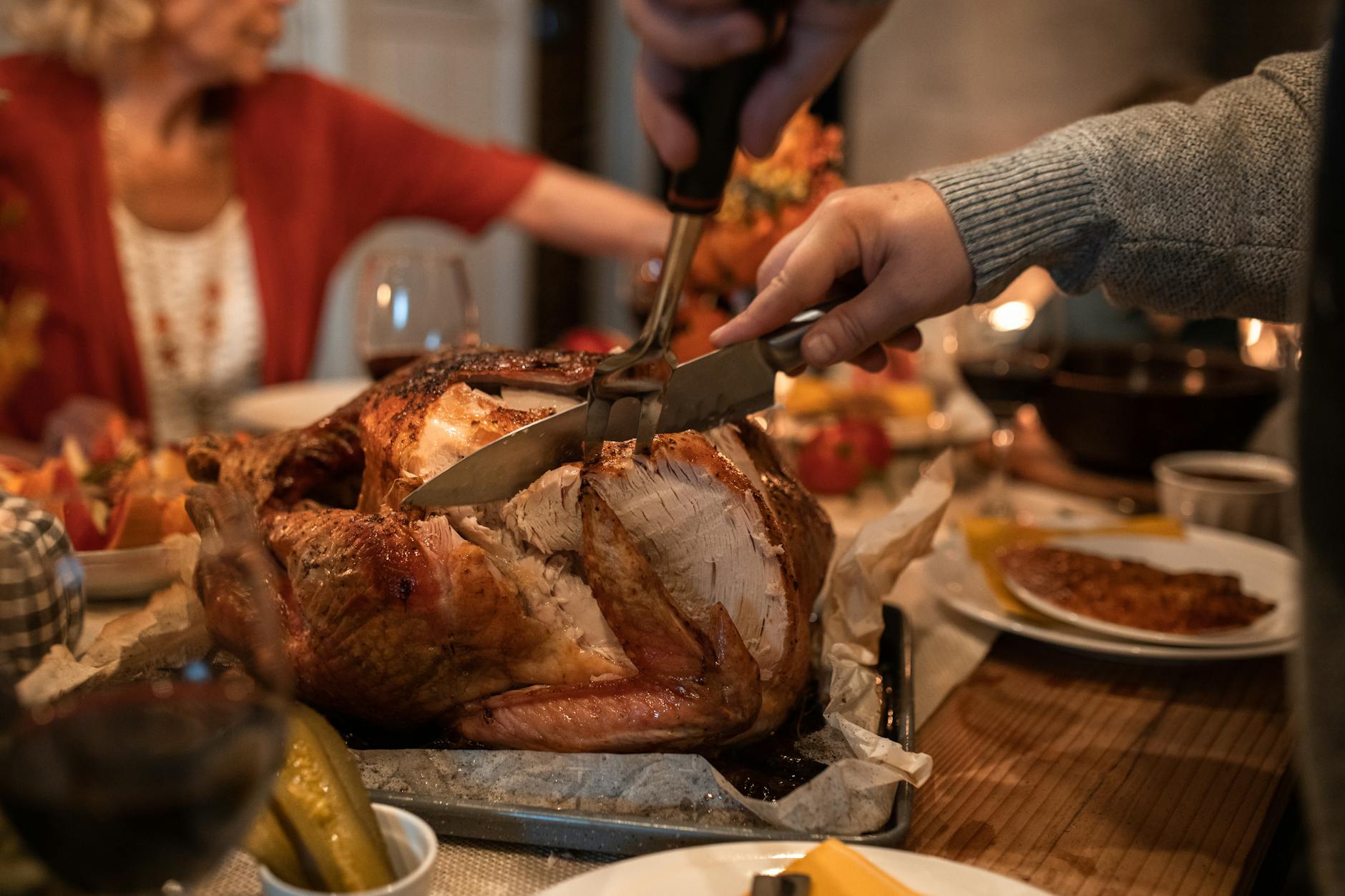 person slicing meat on table