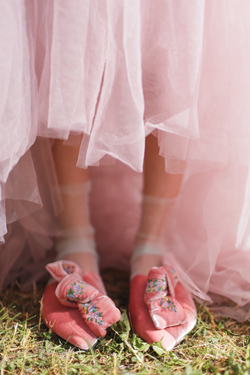 a person wear pink dress and pink shoes