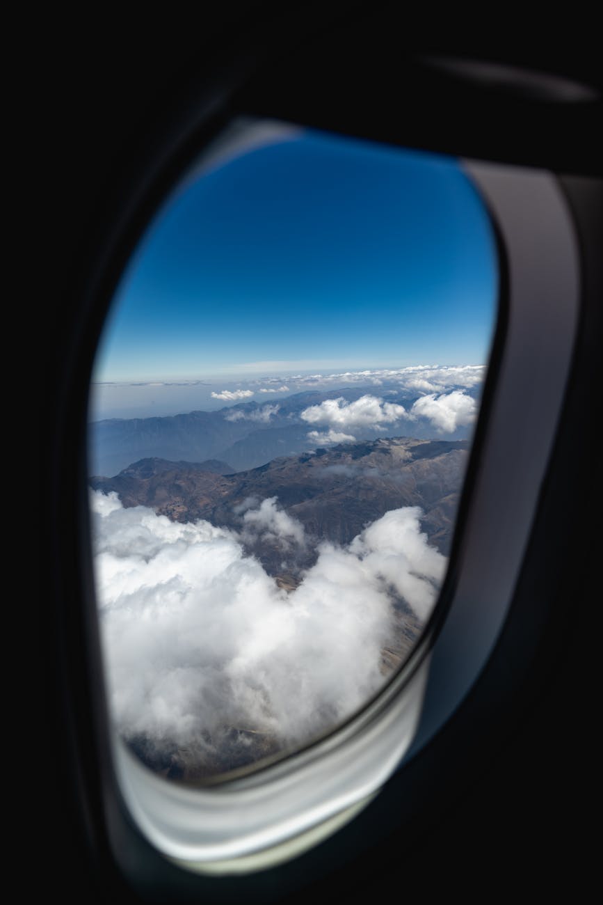 mountains and clouds outside of an airplane window