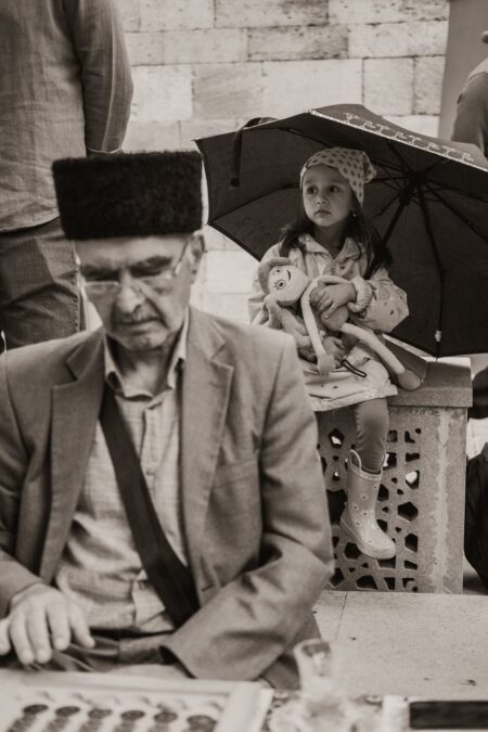 elderly man and a little girl sitting outside