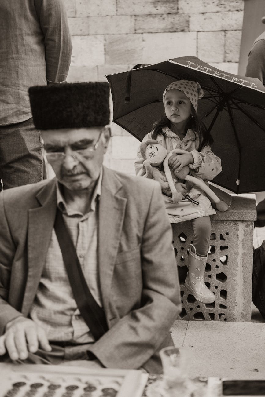 elderly man and a little girl sitting outside