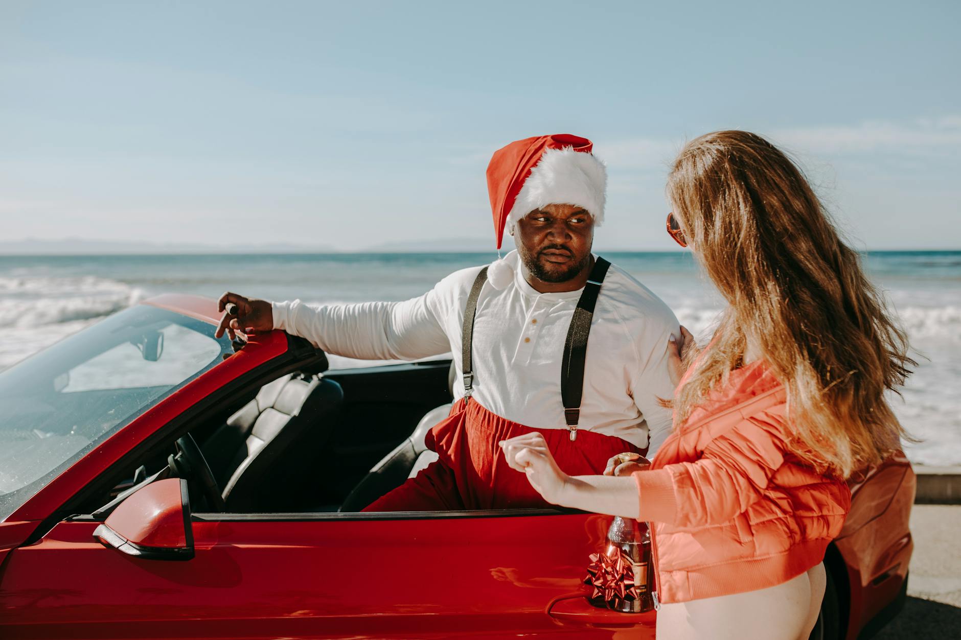a man riding in the red car