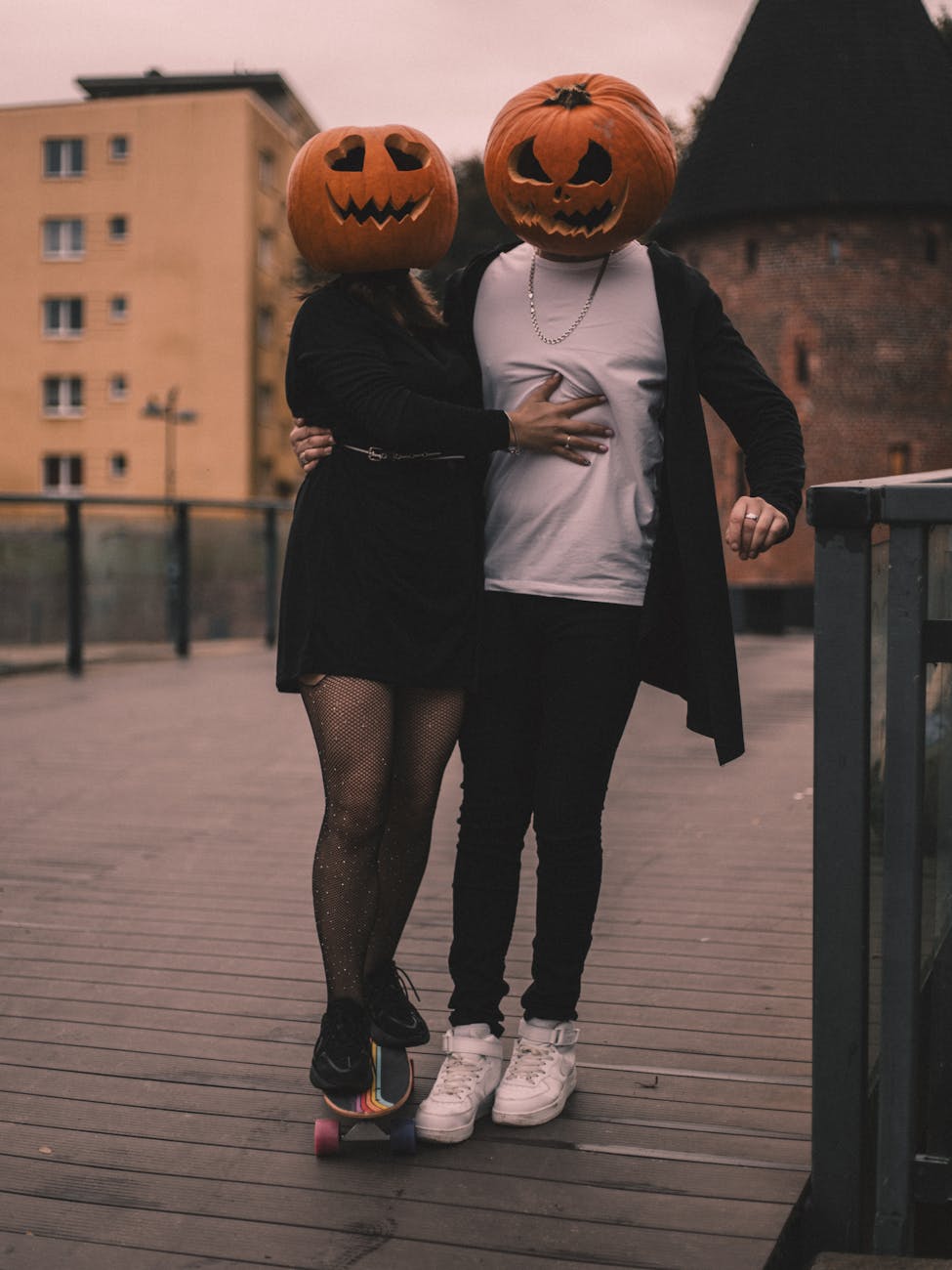 halloween couple with pumpkin heads outdoors