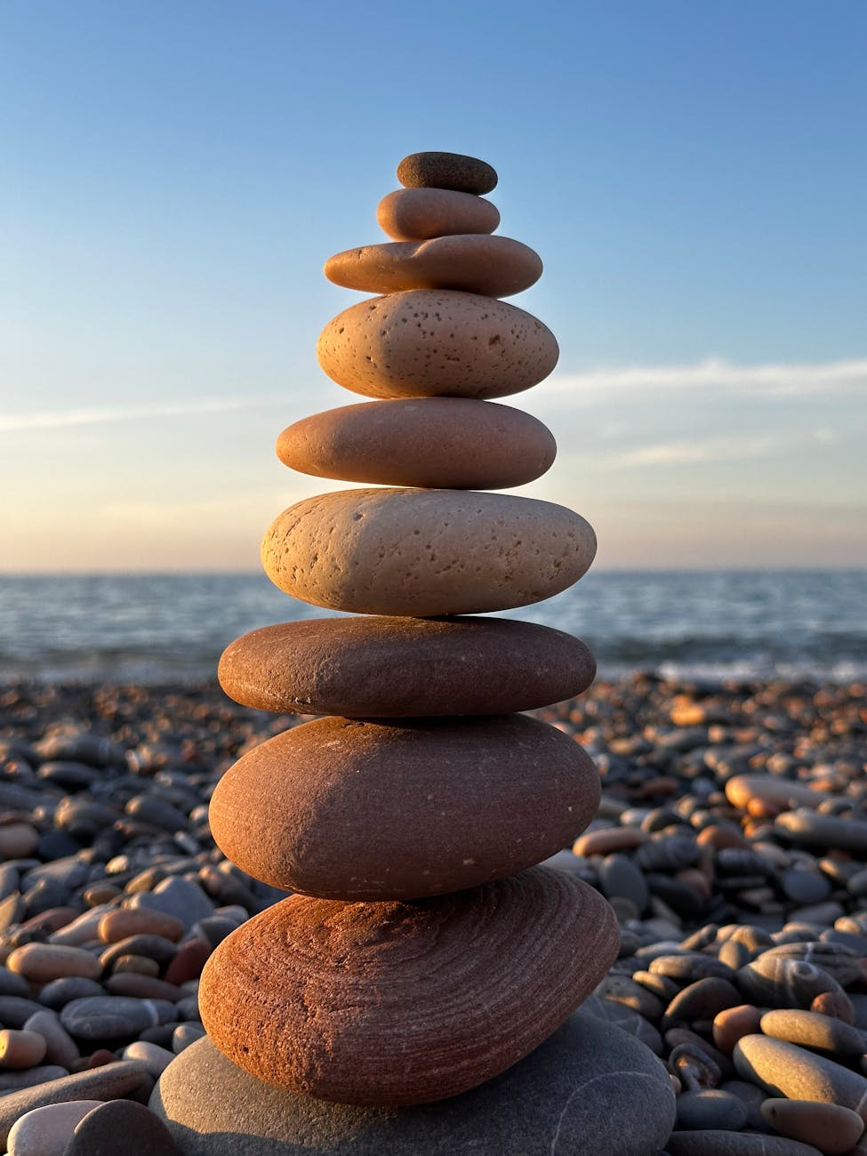 zen stone stack by the seaside at sunset