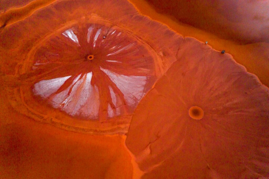 aerial shot of dunes on red desert