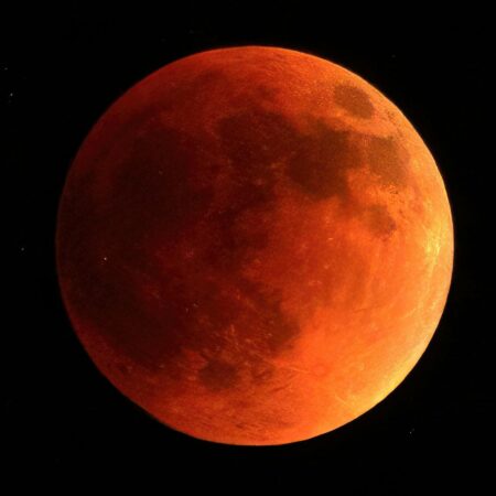 orange moon in black background