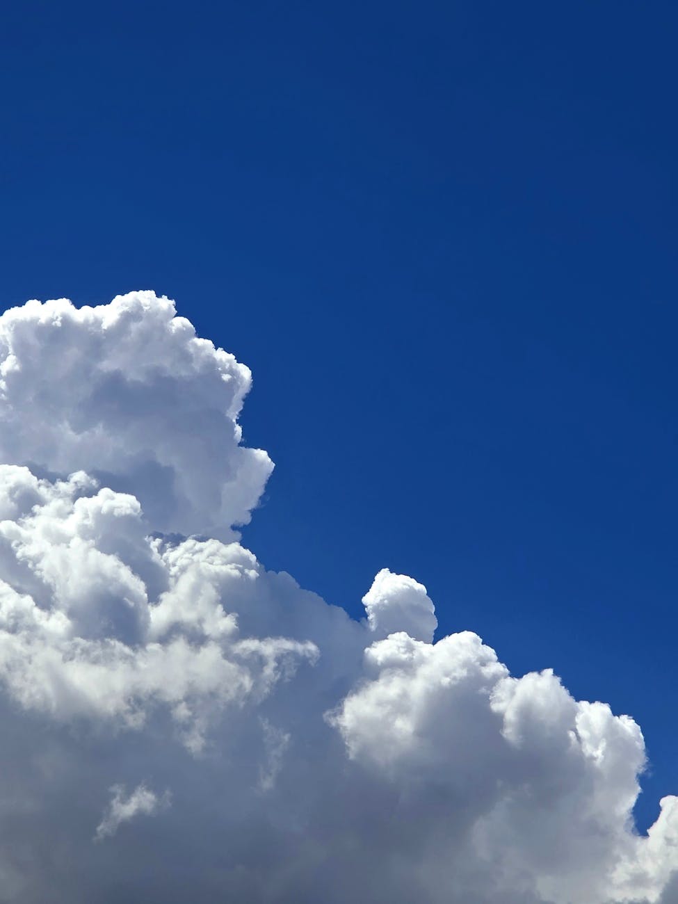 fluffy white clouds against deep blue sky