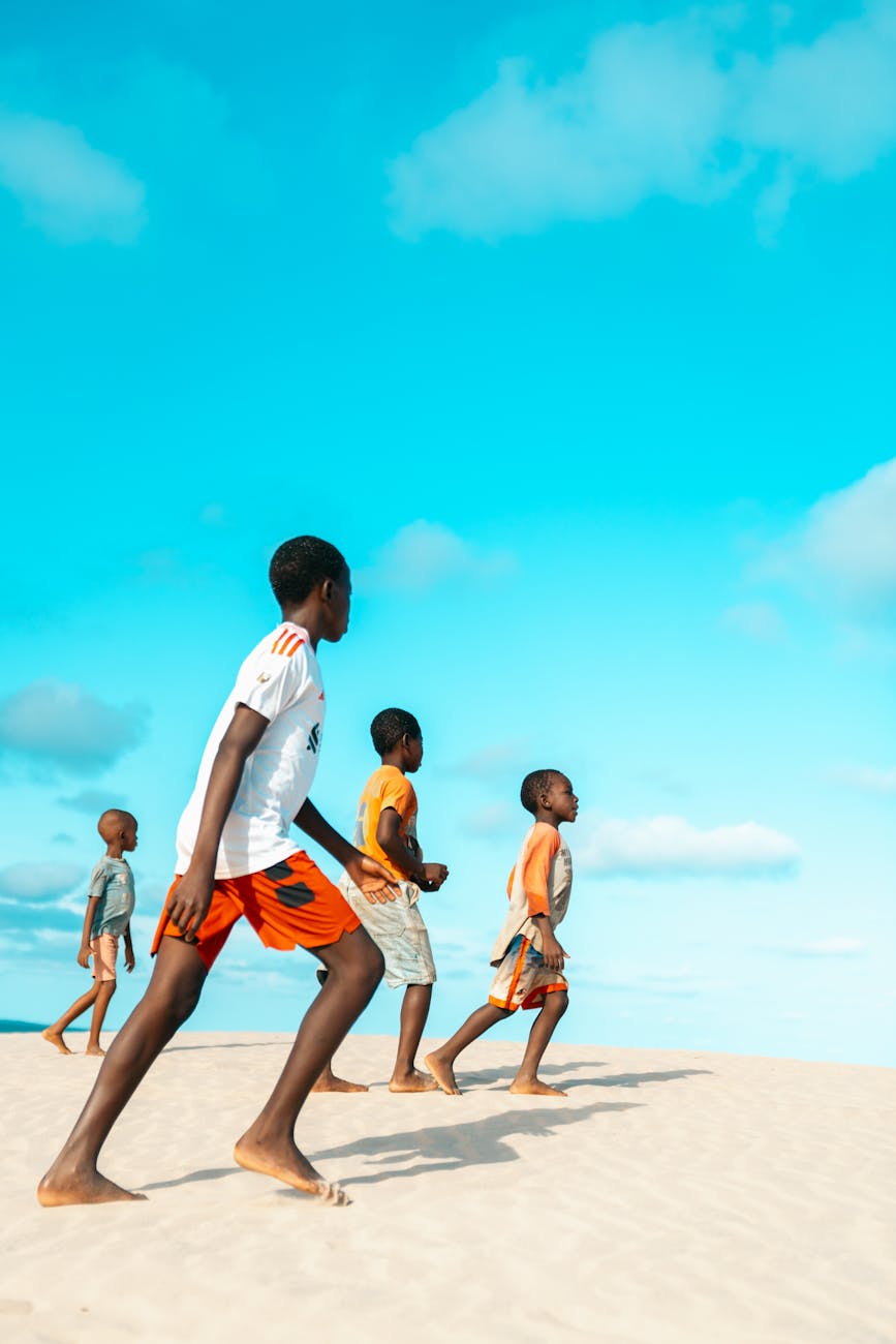 children playing on sand dunes in kenya