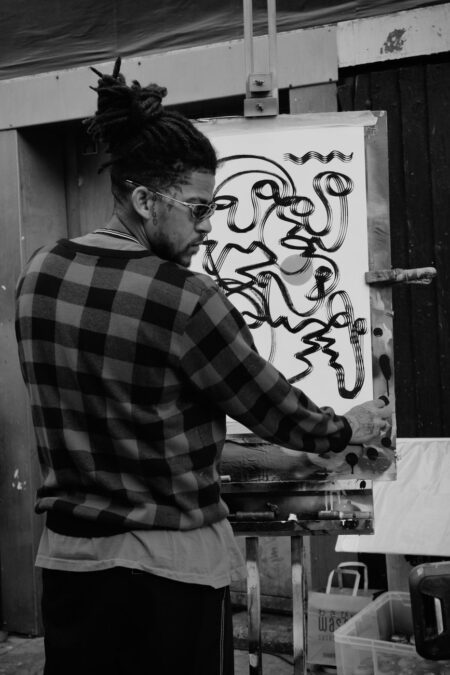 artist with painting in black and white
