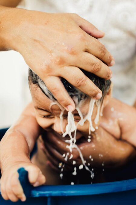 woman cleaning baby hair