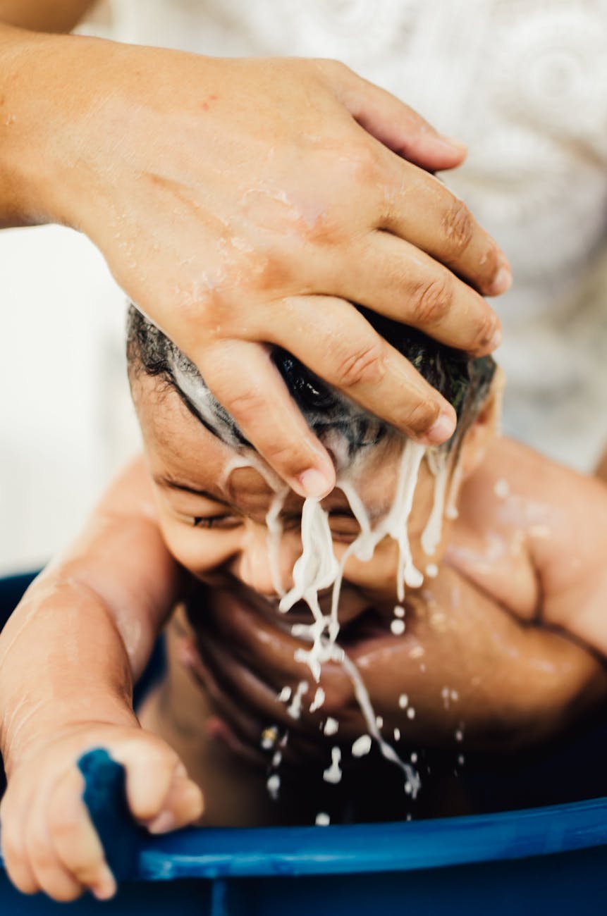 woman cleaning baby hair