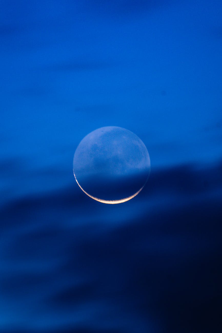 crescent moon in deep blue night sky