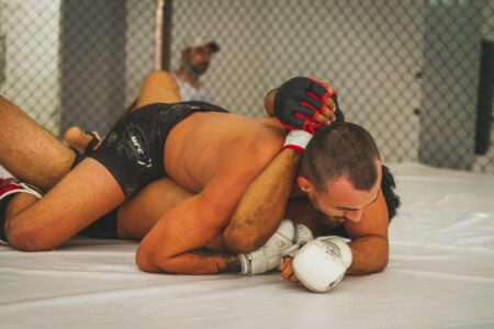 man in black shorts lying on white floor