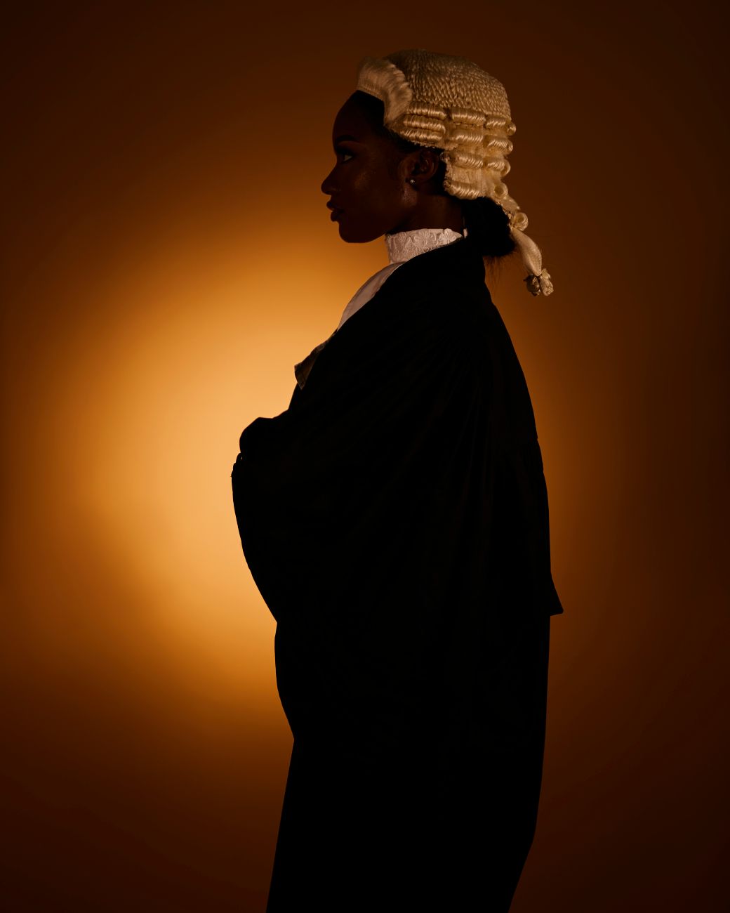 woman in dark coat with white wig on head