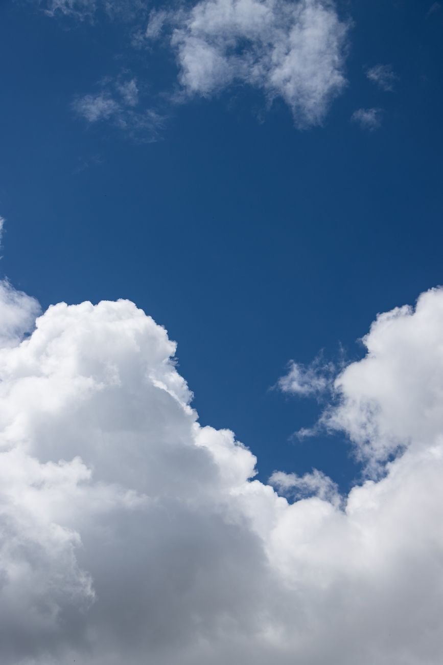 bright cloudy sky with blue background