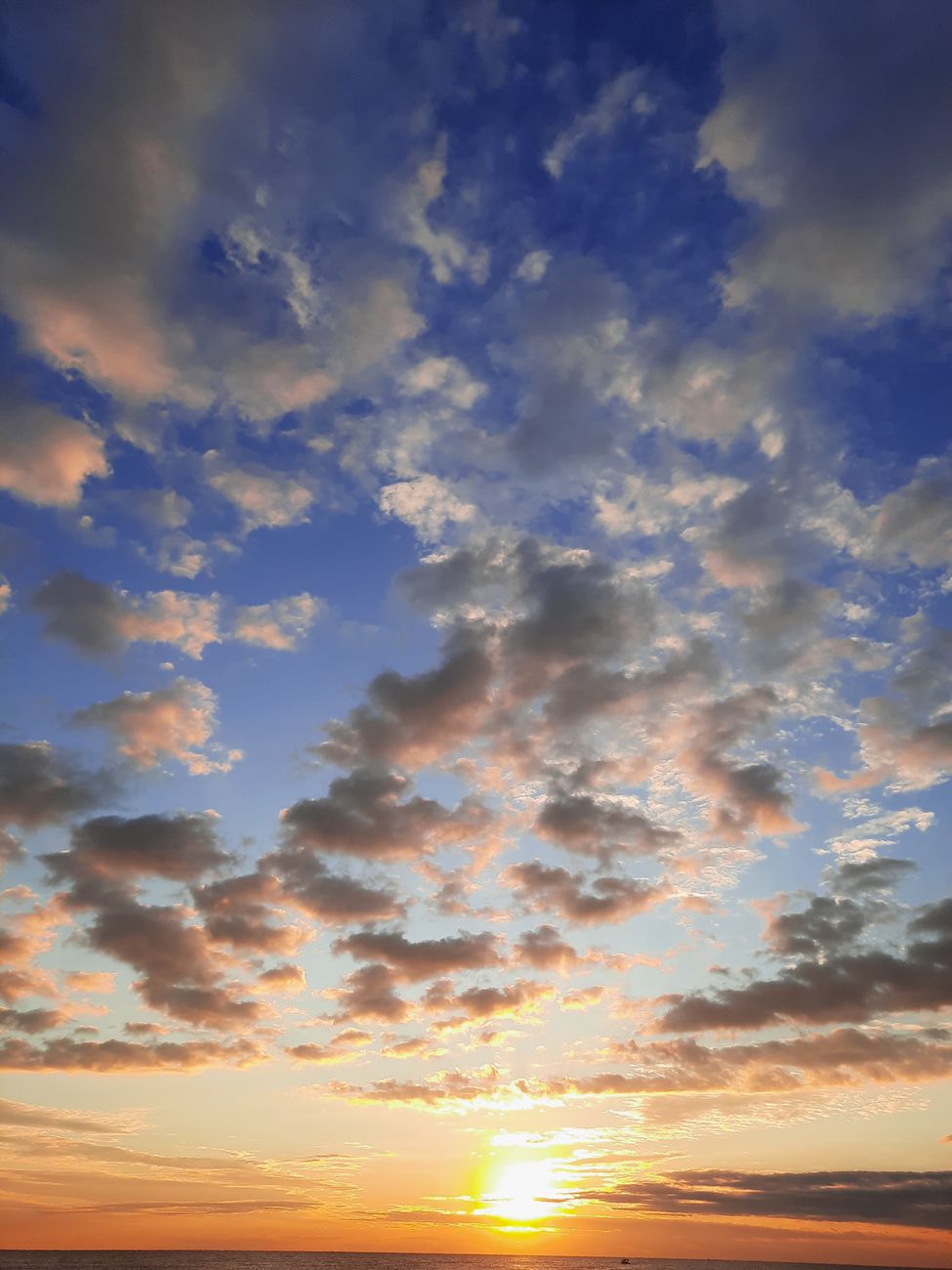 stunning sunrise with cloudscape over ocean horizon