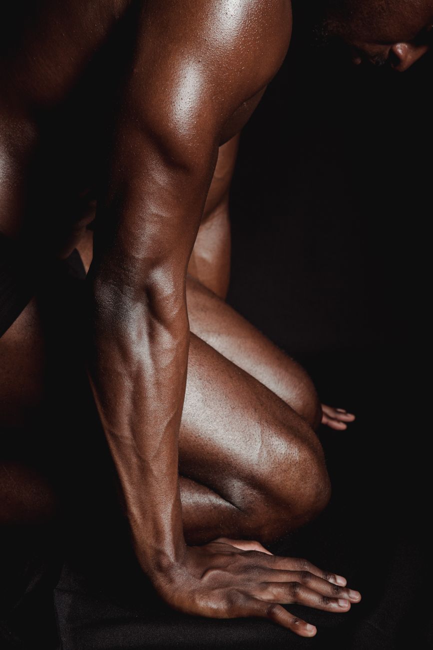 a kneeling naked man