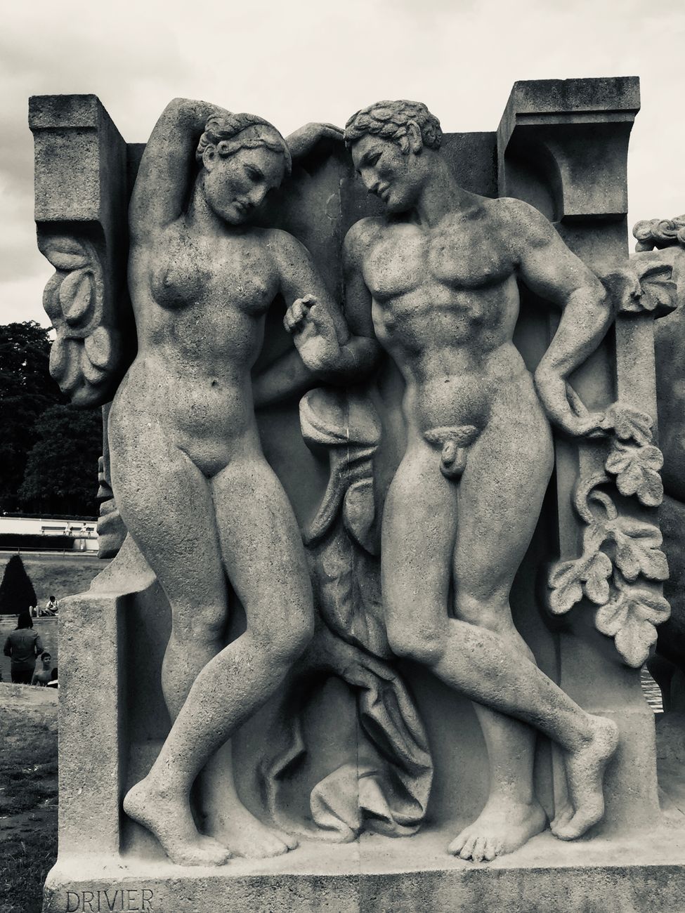 grayscale photo of a concrete statue