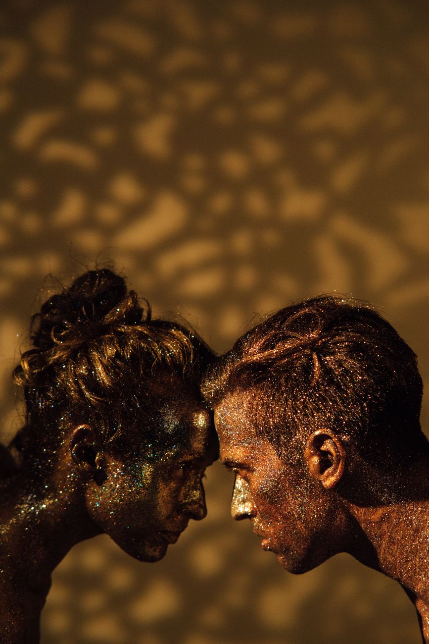 models covered in body paint facing each other