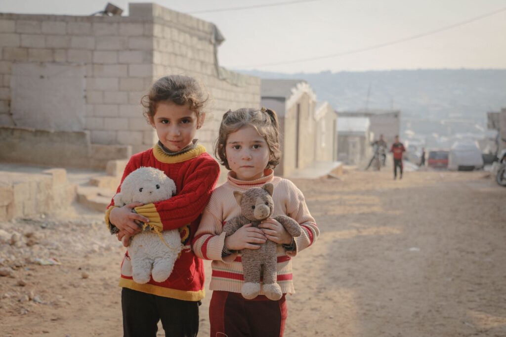 girls holding stuffed animals